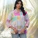 Woman wearing a colorful checkered shirt with a blurred natural background
