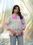 Woman wearing a colorful checkered shirt with a blurred natural background