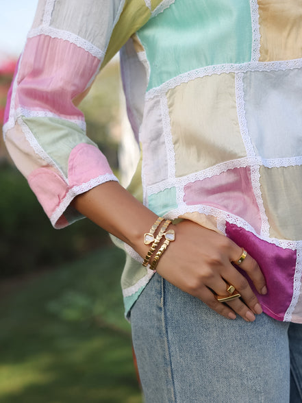 aesthetic shot of a multicolored silk chanderi shirt with a contrast colored cuff design with white laces 