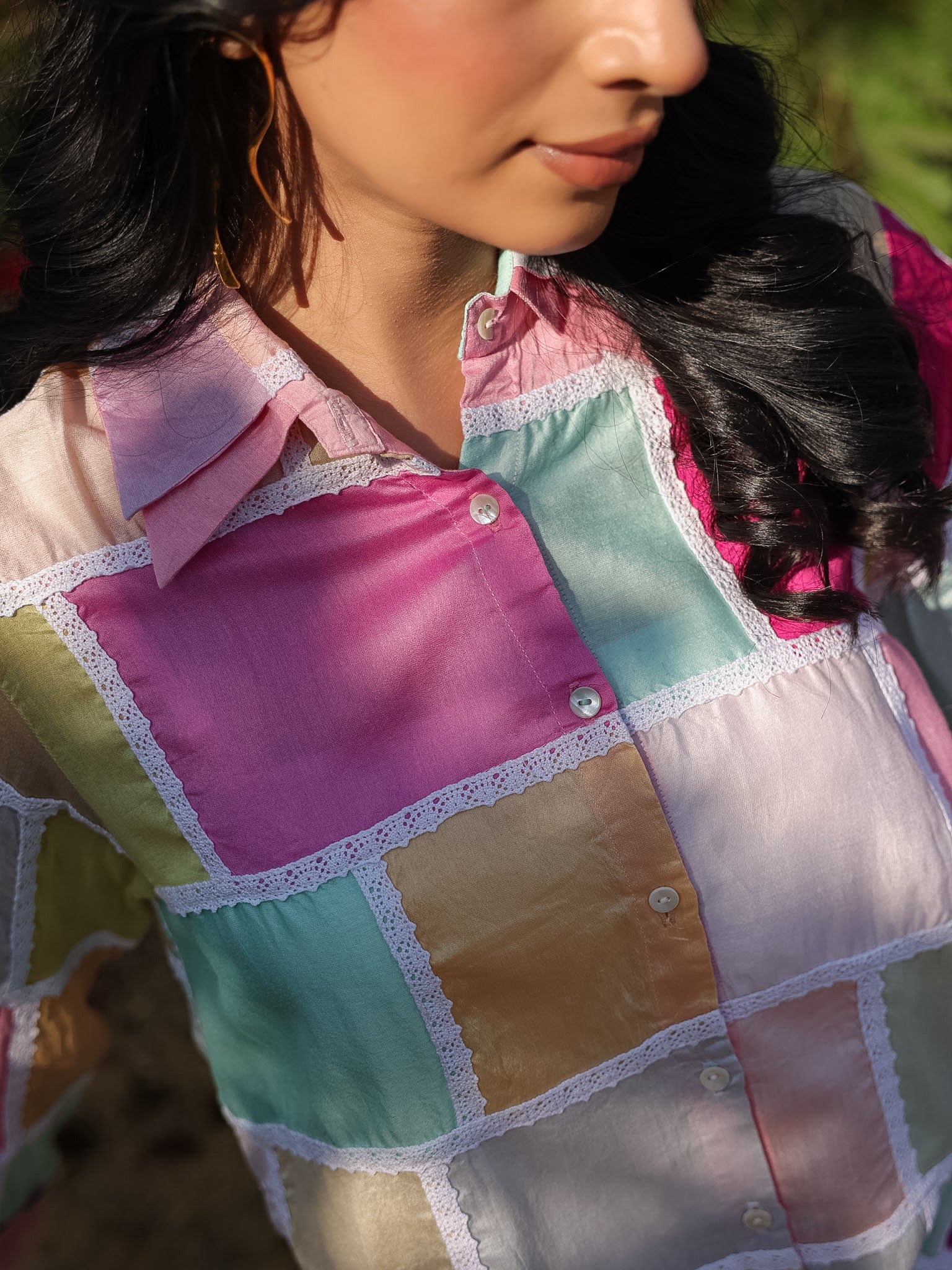 Close-up of an aesthetic colorful patchwork shirt with a blurred background