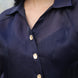 Navy blue shirt with gold buttons worn by a person