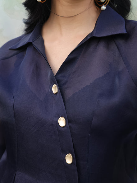 Navy blue shirt with gold buttons worn by a person
