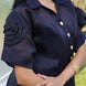 Navy blue satin organza shirt with gold buttons worn by a person, blurred background