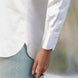 closeup of hem and sleeve details of white shirt