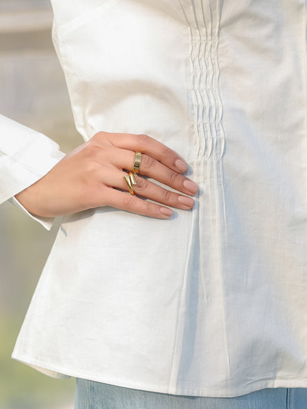 closeup of white shirt with pin tucks detailing worn by a woman 
