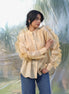 woman wearing a luxurious silk chanderi beige ruffled shirt