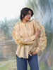 woman wearing a luxurious silk chanderi beige ruffled shirt