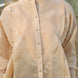 beige shirt with golden buttons and gathered front slant panels