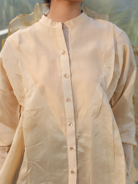 beige shirt with golden buttons and gathered front slant panels