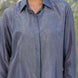 Grey Silk Dori embroidered shirt worn by a person with a blurred natural background