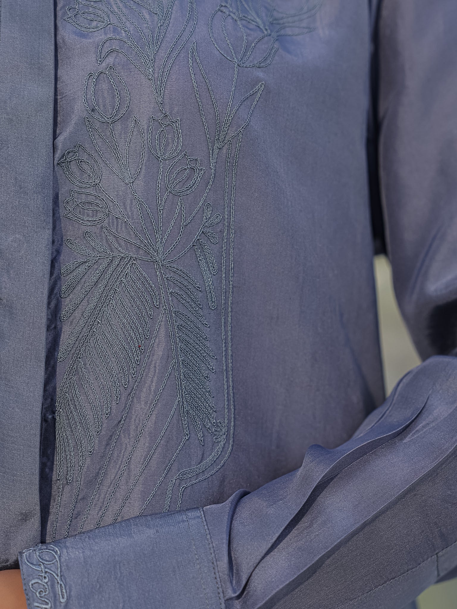Close-up of a greygarment with grey tulip dori embroidery