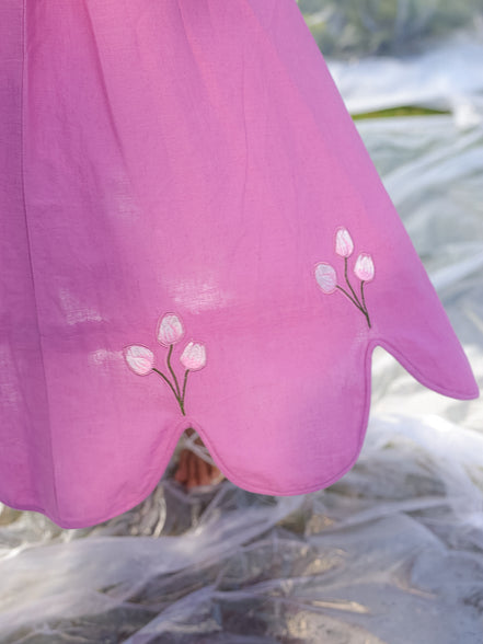 aesthetic shot of pink cotton linen skirt which has beautiful cut to its hem and tulip embroidery is delicately appliqued on the points