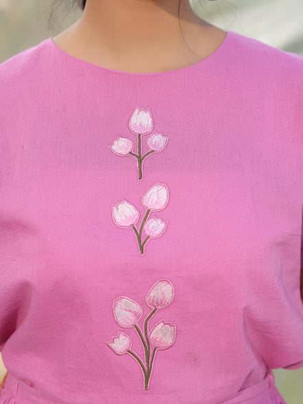 closeup of pink top with tulip embroidery which is appliqued