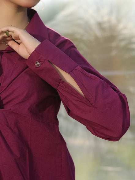 a stylish cuff of a wine shirt with golden buttons