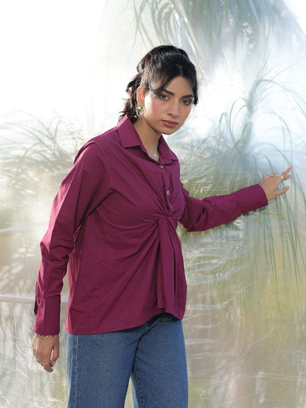an aesthetic shot of a woman weaeing a stylish and designer marron wine red shirt