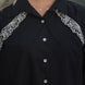 white intricate tulip resham embroidery in frot on a black shirt