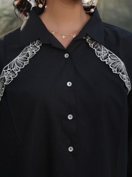 white intricate tulip resham embroidery in frot on a black shirt