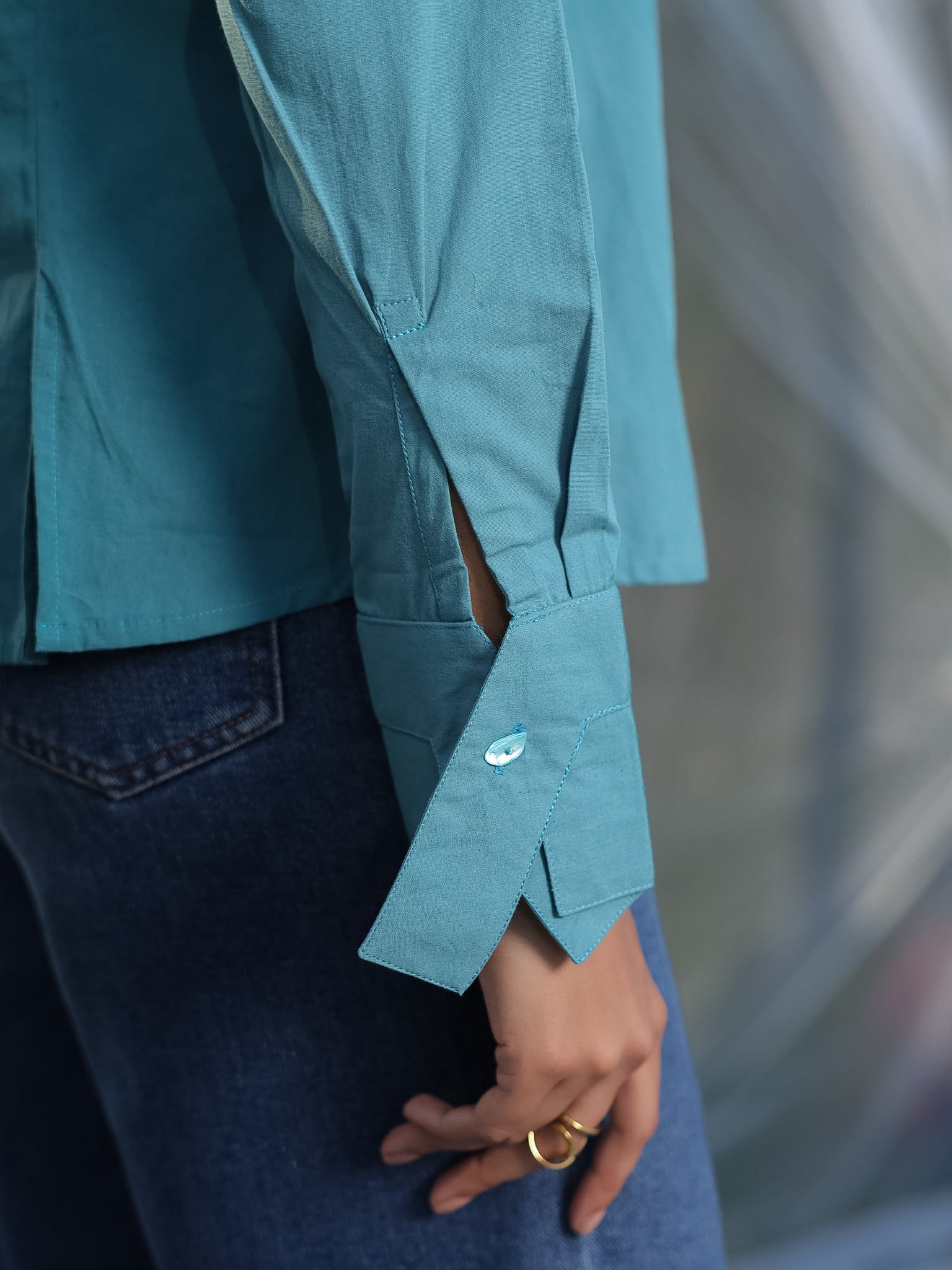 aesthetic cuff design of a teal blue shirt
