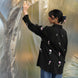woman wearing black jacket with delicate and stylish tulips embroidery all over the shirt with connector lace