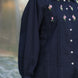 aesthetic shot of a woman wearing navy blue cotton shirt with beautiful and elegant floral embroidery with pintucks