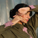 aesthetic shot of a woman wearing an olive green shirt with contrast pink tulip embroidery patches