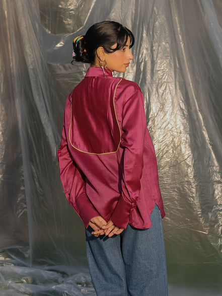 person wearing a maroon ilk chanderi shirt with contrast piping yoke in the b ack